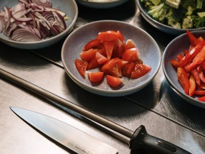 A detailed close-up of fresh vegetables and kitchen tools for cooking.